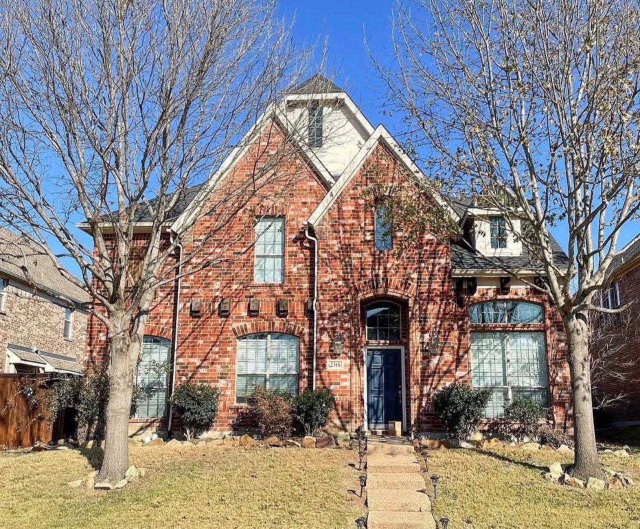 Red-brick house with pale trim before the exterior refresh