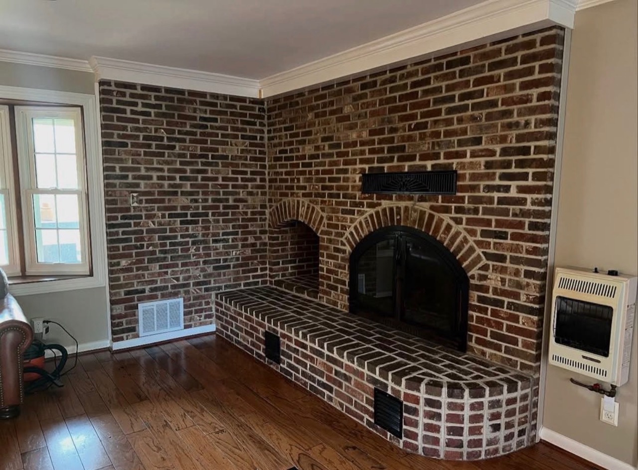 Dark brick fireplace and raised hearth before the finish update