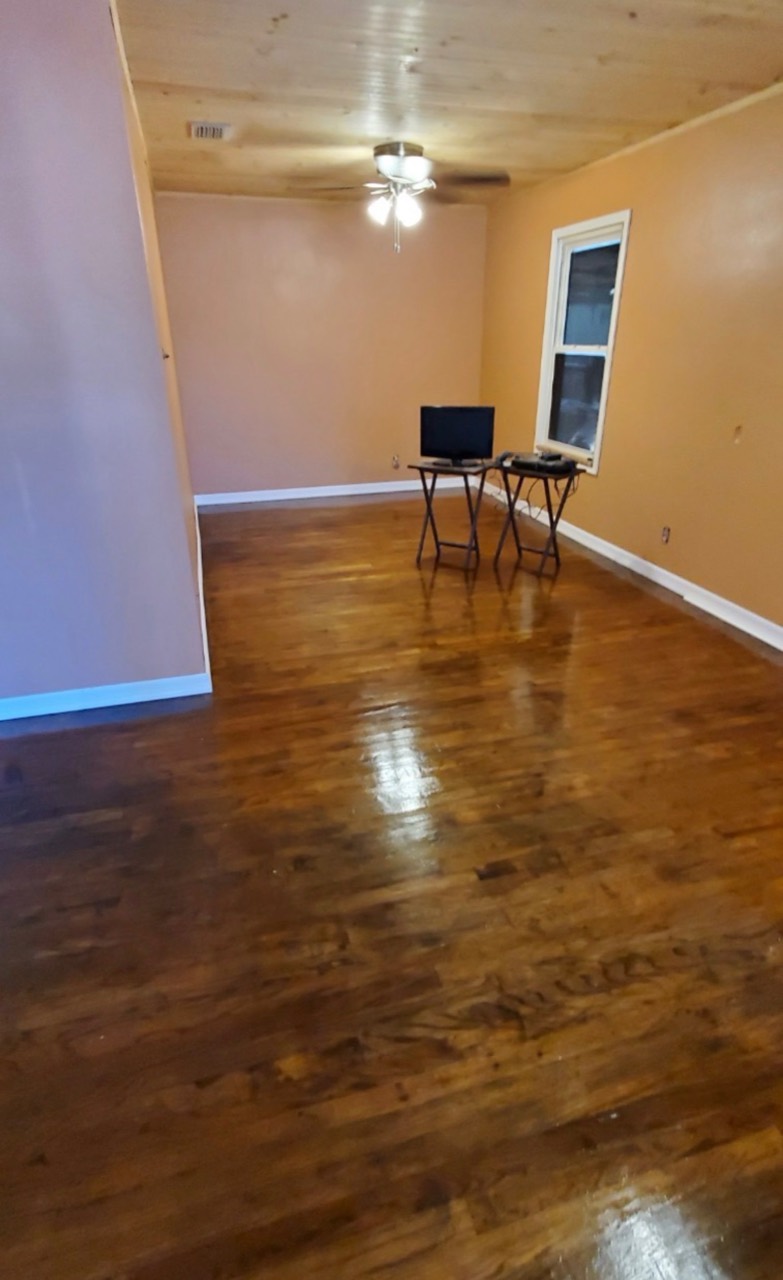 Finished room with warm walls, wood floor, and wood ceiling
