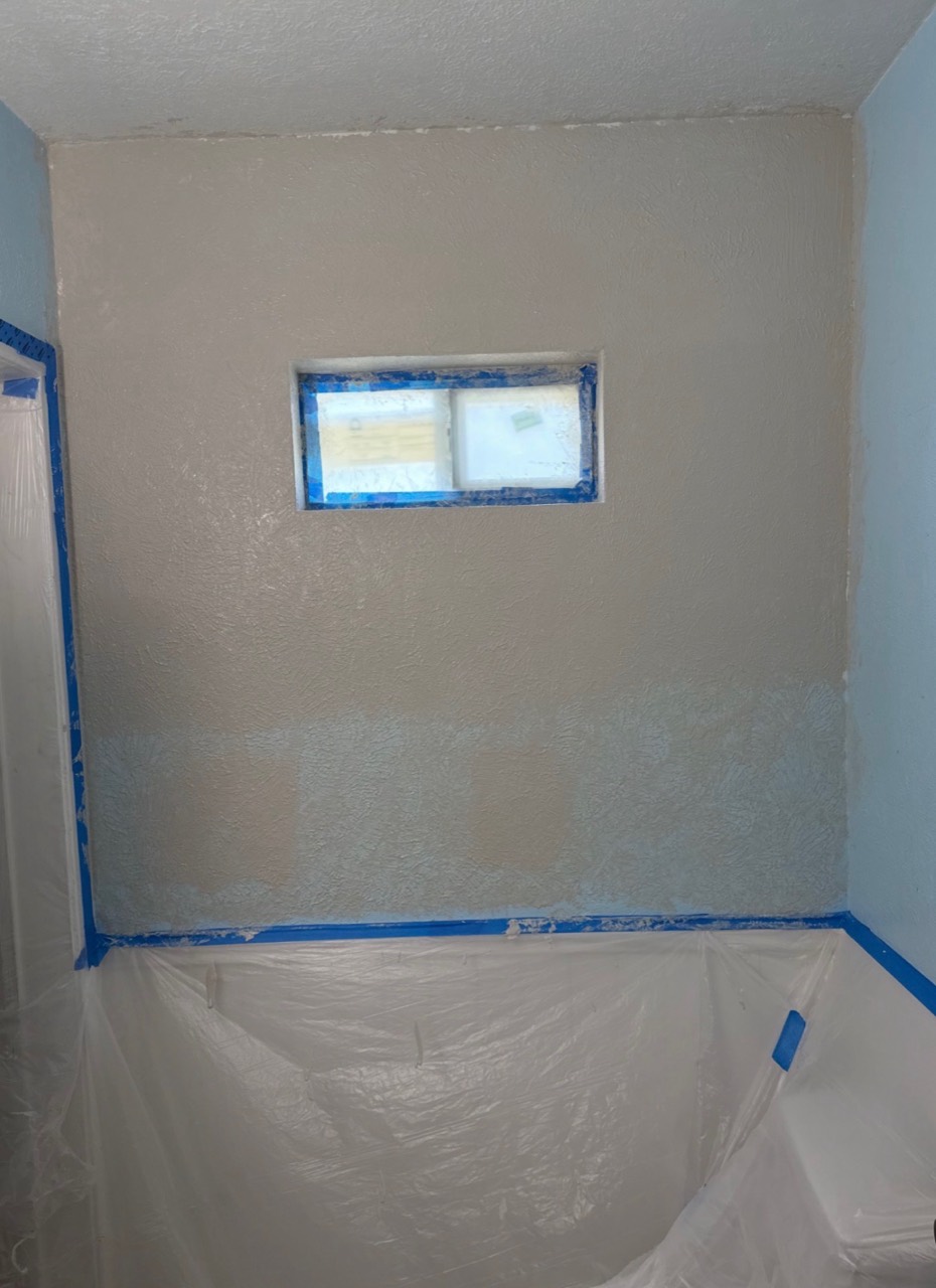 Patched and textured window wall with masking still in place